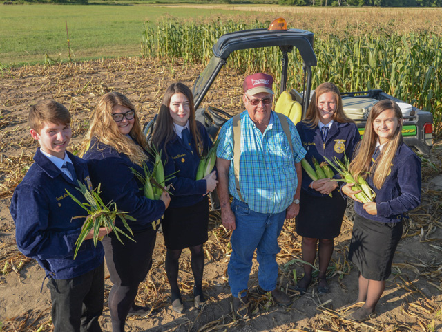 Farmer Nick Allen donates sweet corn for Troy, Missouri, FFA Chapter members to distribute to nursing homes and food pantries. Allen is shown here with (left to right) Jacob Love, Emilee Harris, Grace Rhodes, Kelsey Sachs and Lexi Collins. (Photo by Gregg Hillyer) 